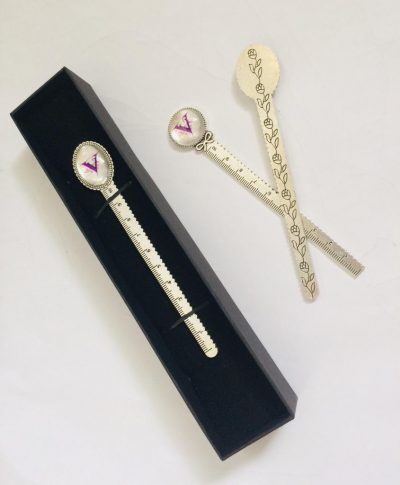 Image shows three bookmarks - one in the presentation box and two loose, one showing engraving on the back of the bookmark and one showing the front. Handmade bookmark/letter opener